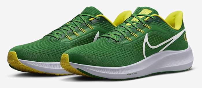 Side view of green and yellow Nike running shoes.